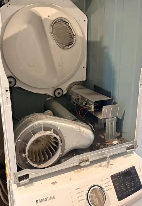 Samsung dryer with the front removed showing the blower housing and heater