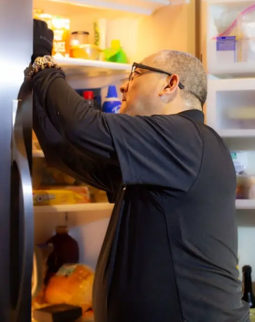 Technician checking the inside of a home refrigerator in Utah